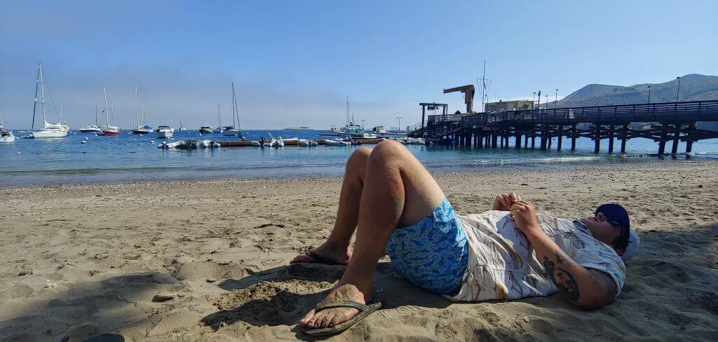 Laying on the beach of Two Harbors on Catalina Island